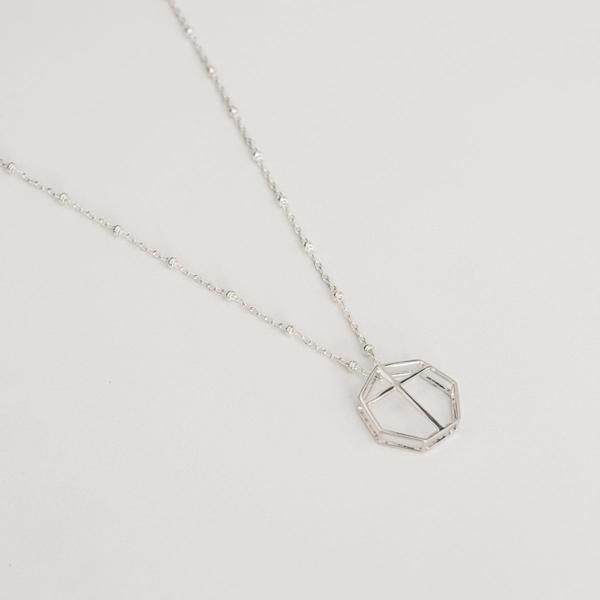 Polished silver, 14k gold plated brass 3D printed metal geometric pendant on satellite chain. 16 inches chain length. 